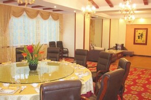 A conference room with a round table, chairs, and a chandelier. - Friendly Hotel (Shaoguan Nanhua Temple) (Shaoguan)