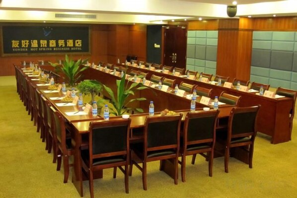 A conference room with long tables and chairs, equipped with nameplates and water bottles. - Friendly Hotel (Shaoguan Nanhua Temple) (Shaoguan)