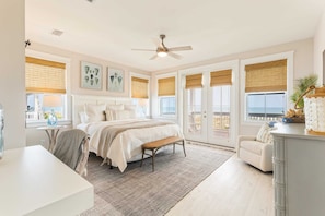 A bedroom with a bed, bedside tables, a bench, a desk, and a chair. - Frazer Oceanfront Beach House with Elevated Infinity Pool! (Premier Bella Proper (Port St. Joe)