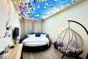 A room with a bed, a hanging chair, and a ceiling mural. - Fenglin Art Hotel (Pingle)