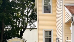 A residential garden with a pathway, various plants, and a shed. - Cozy Modern Farmhouse Private Apt - 3 Beds (Torrington)