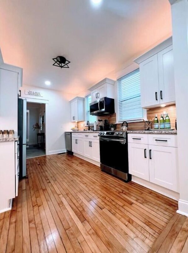 Enjoy cooking in this well-equipped kitchen with a stainless steel stove, microwave, and dishwasher.