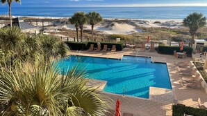 A swimming pool with a view of the beach and ocean.