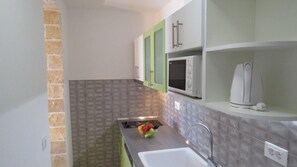 Fridge, microwave, stovetop, coffee/tea maker