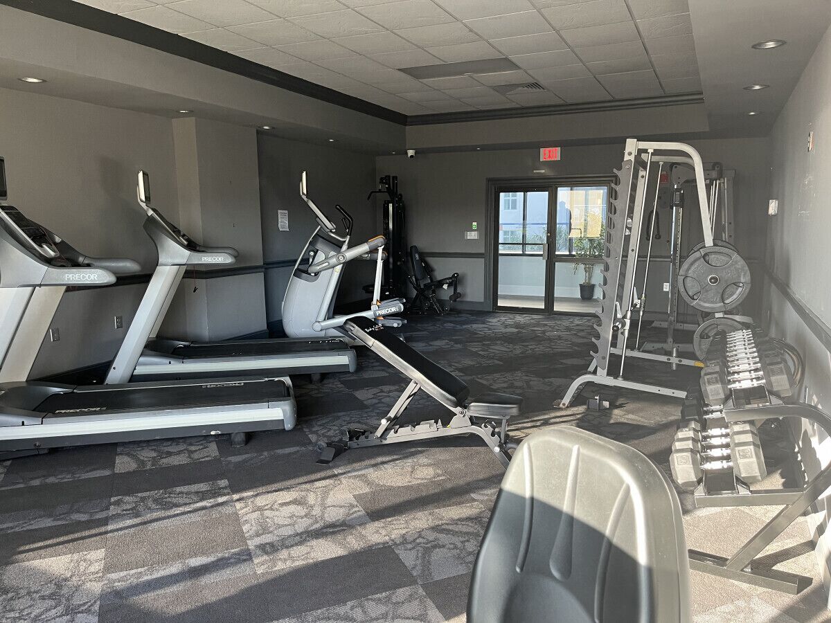 A gym with treadmills, a stair climber, and weight machines.