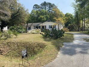 A single-story house with a front yard, a cactus plant, and a sign indicating the property number 1793 APT B. - Driftwood Suite . Close to CCU. 1bd/1 ba Apartment (Conway)
