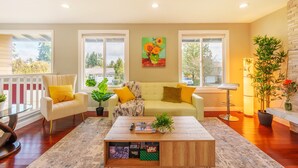 A modern living room with a sofa, armchairs, a coffee table, and large windows. - Spacious remodeled home with central AC and fenced yard (Kirkland)