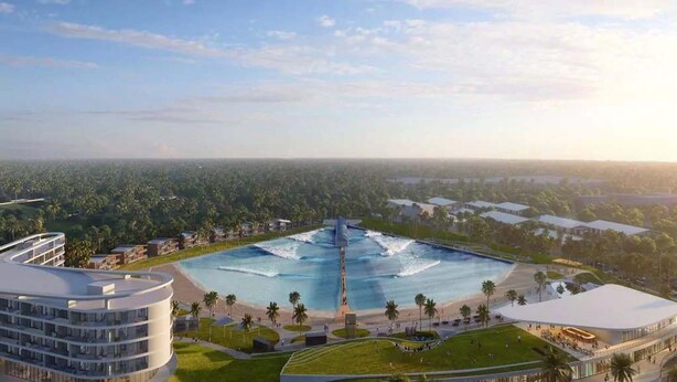 A resort with a large central pool, multiple buildings, and surrounding greenery. - Upper-Floor Ocean Breeze  - Surf Views 2BR (Fort Pierce)
