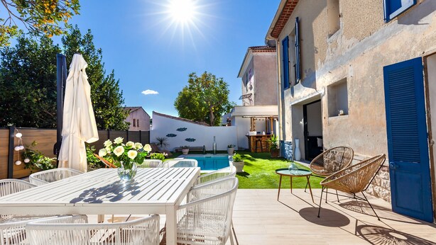 A patio with a pool, outdoor furniture, and a building with blue shutters. - House with swimming pool 10 minutes walk from the beach  (Toulon)