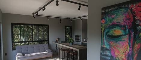 Casa Buda I - Piso Superior - Garopaba - SC | Living area | 50-inch Smart TV with cable channels, TV, fireplace