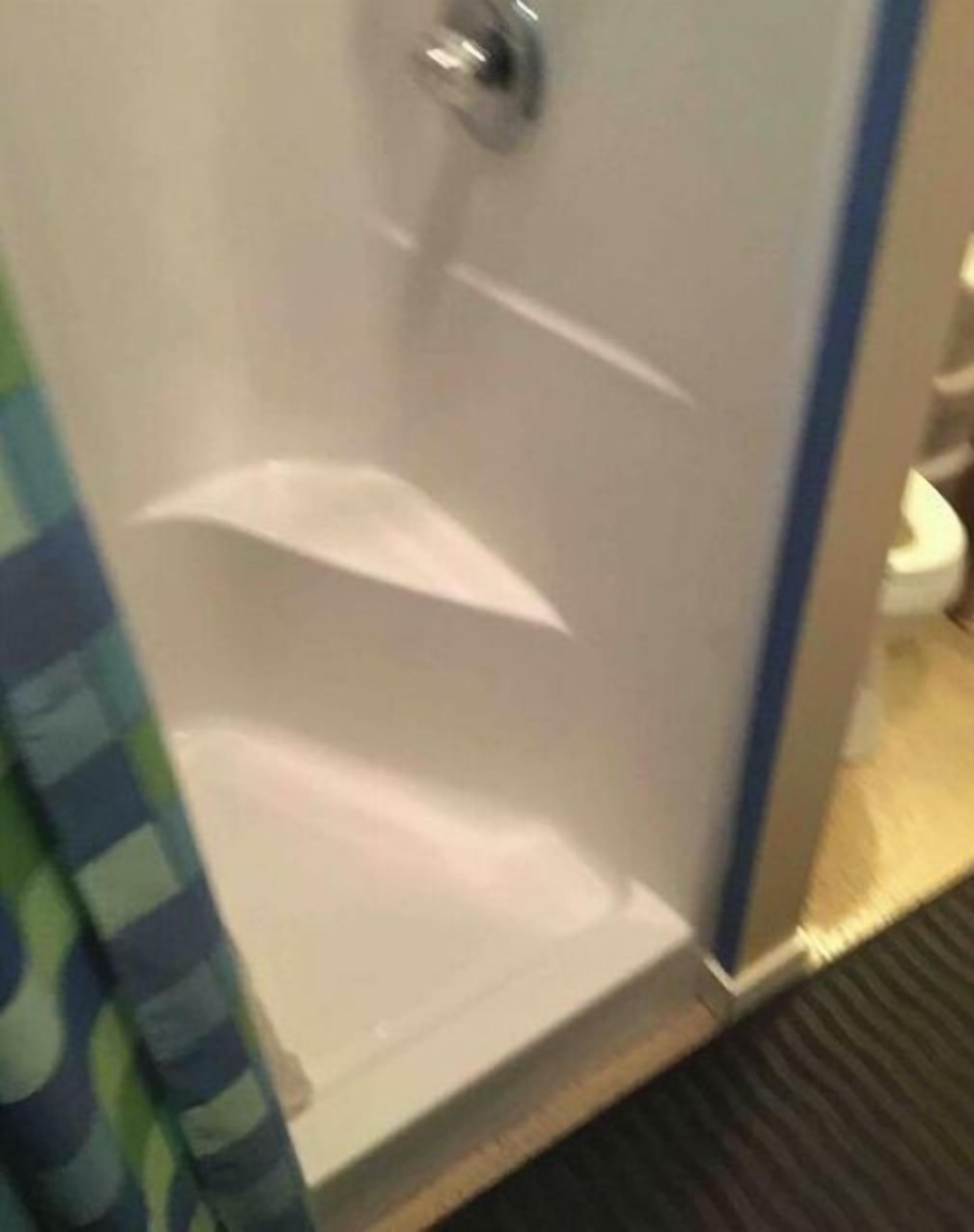 A bathroom with a shower, a toilet, and a sink.