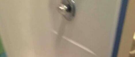 A bathroom with a shower, a toilet, and a sink.