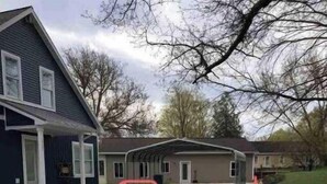 A residential area with houses, a driveway, and a sign that reads "Park Under Carport." - Family Legacy Resort, Making great family memories (Allegan)