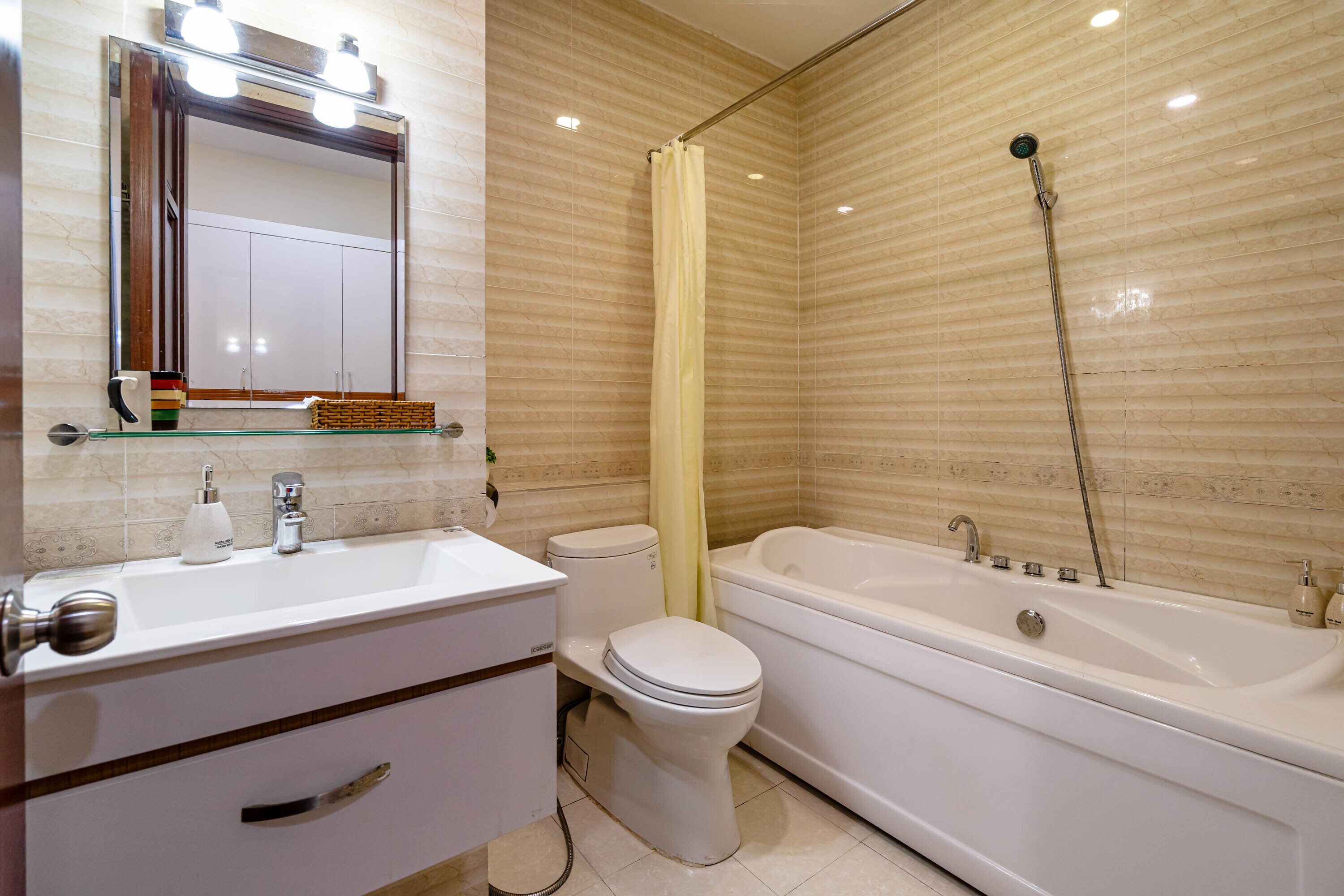 A bathroom with a white sink, toilet, and bathtub.