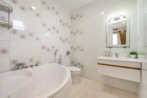 Superior Room | Bathroom | Combined shower/bathtub, deep-soaking bathtub, rainfall showerhead - WE HOME Japan Town (Ho Chi Minh City)