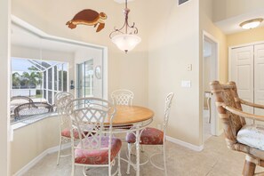 Enjoy meals in this elegant dining area with a round table and comfortable seating for all.