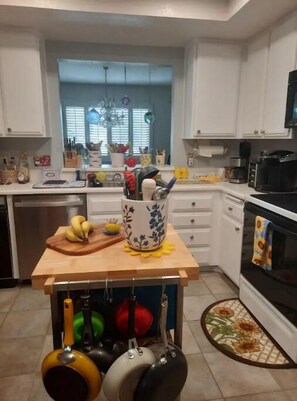 Kitchen features a sink, coffee maker, toaster, and ample storage for cookware.