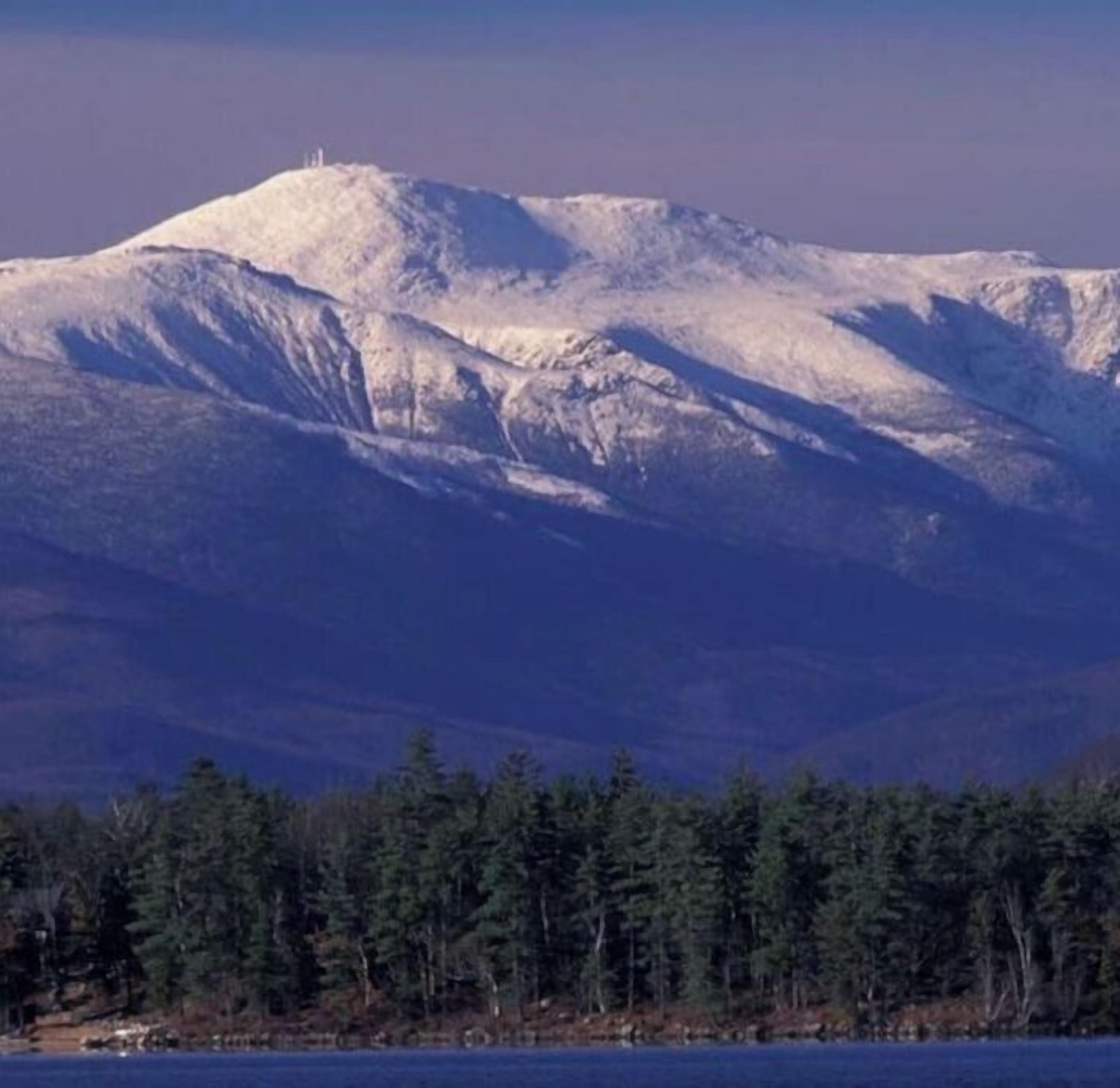 A snow-covered mountain with a clear sky.