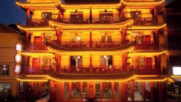 A multi-story building with traditional architecture, featuring balconies and a central entrance.