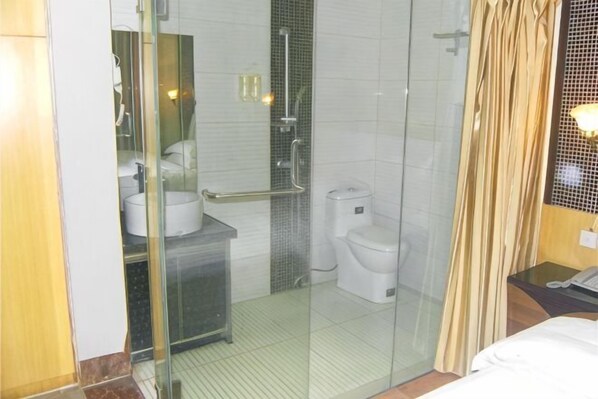A bathroom with a glass shower enclosure, a toilet, and a sink. - Shuangxi Hotel (Hechi)