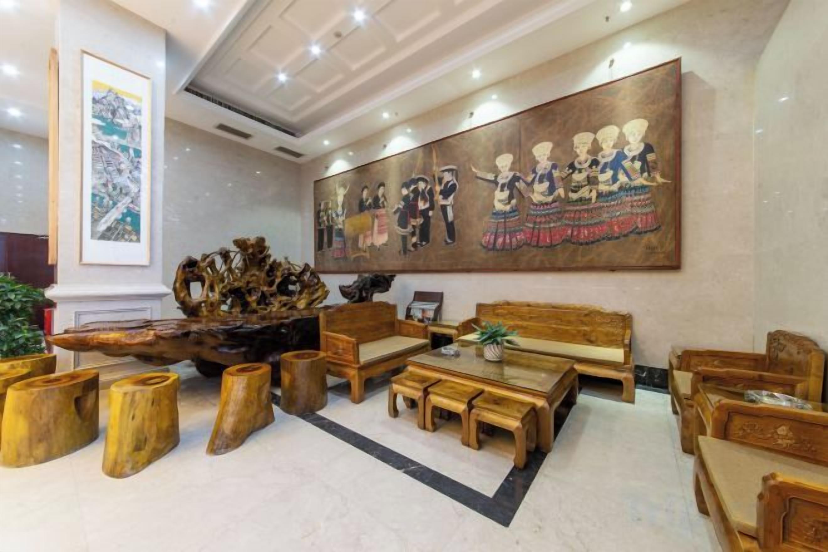 A lobby with a large mural, wooden furniture, and a unique centerpiece.