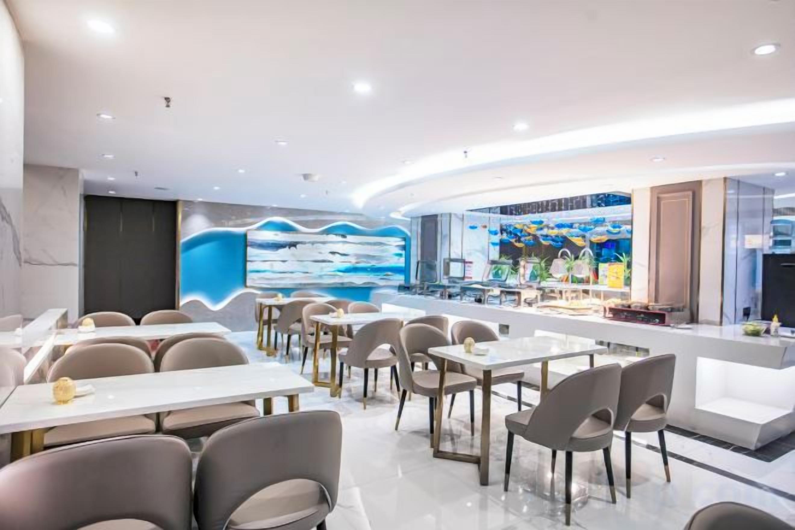 A modern restaurant with a curved counter, multiple tables, and chairs.