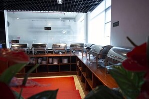 A buffet area with multiple food stations and a red carpet. - Yi Jia Hotel (Zhuhai)