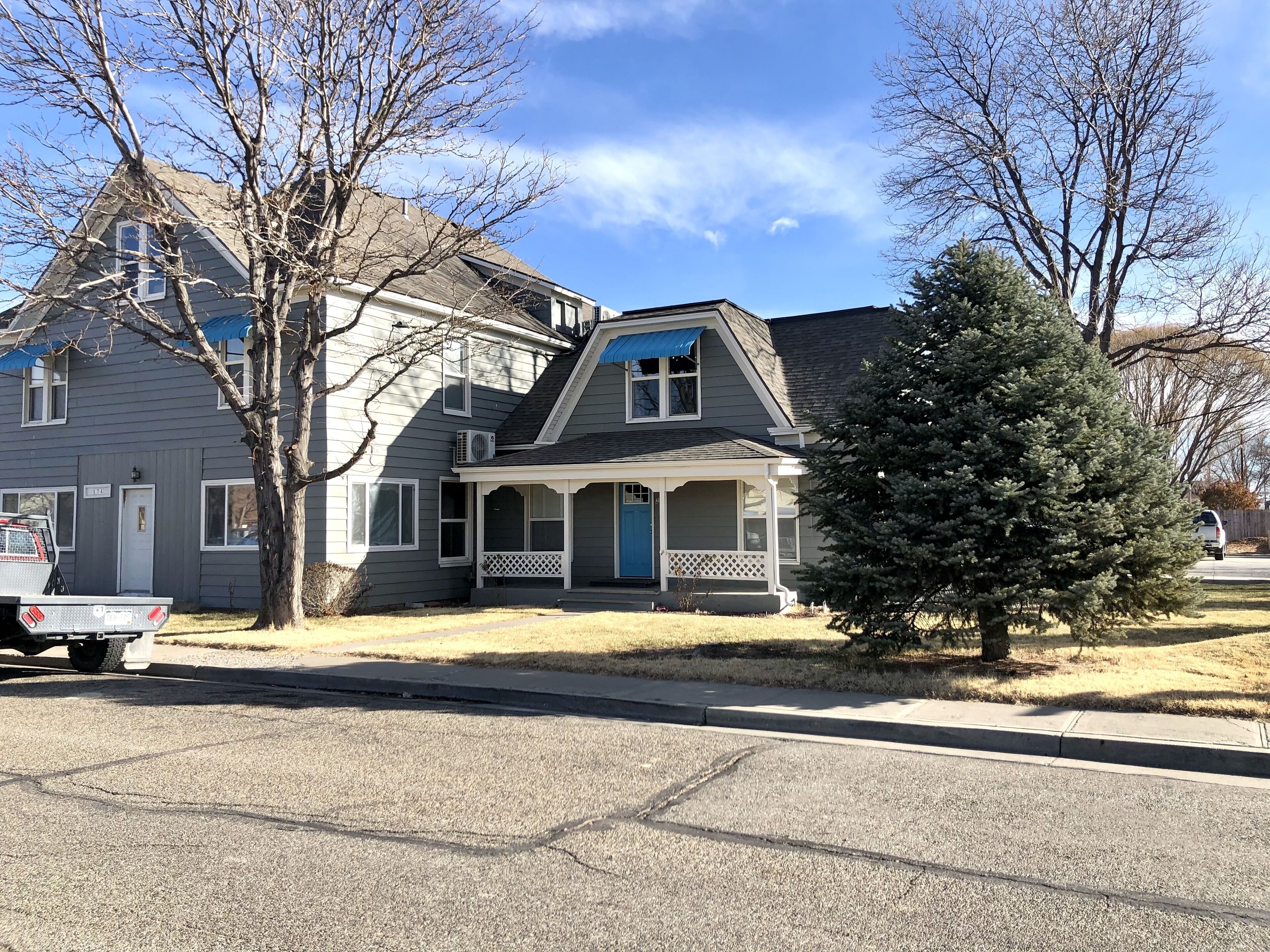 A two-story house with a porch and a garage.