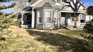 A two-story house with a covered porch, a chimney, and a satellite dish. - Unique downtown Fruita apartment with bike storage! (Fruita)