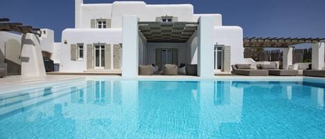 An infinity pool, pool loungers