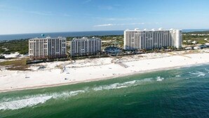 A beachfront hotel complex with multiple high-rise buildings, a sandy beach, and ocean views.