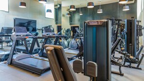 A gym with treadmills, elliptical machines, and weightlifting equipment.