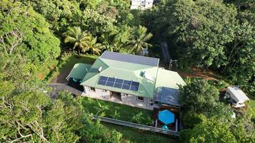 Nestled among lush greenery, this home offers a secluded retreat with a focus on sustainable energy.