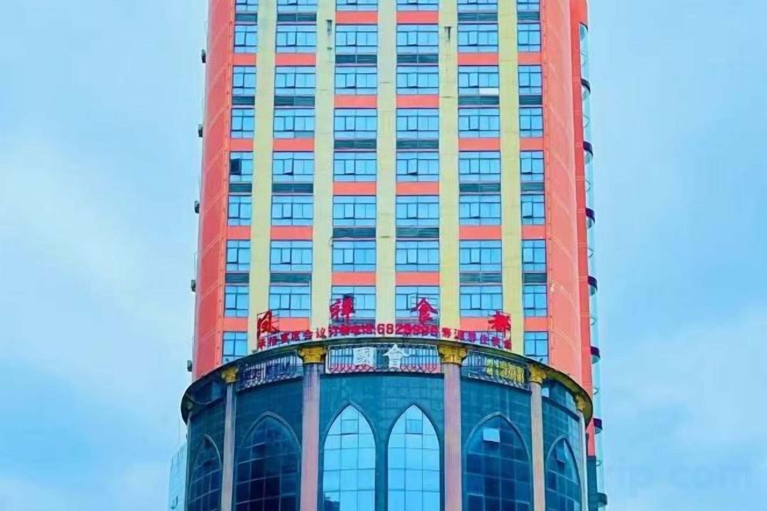 A tall building with a circular base and multiple windows.