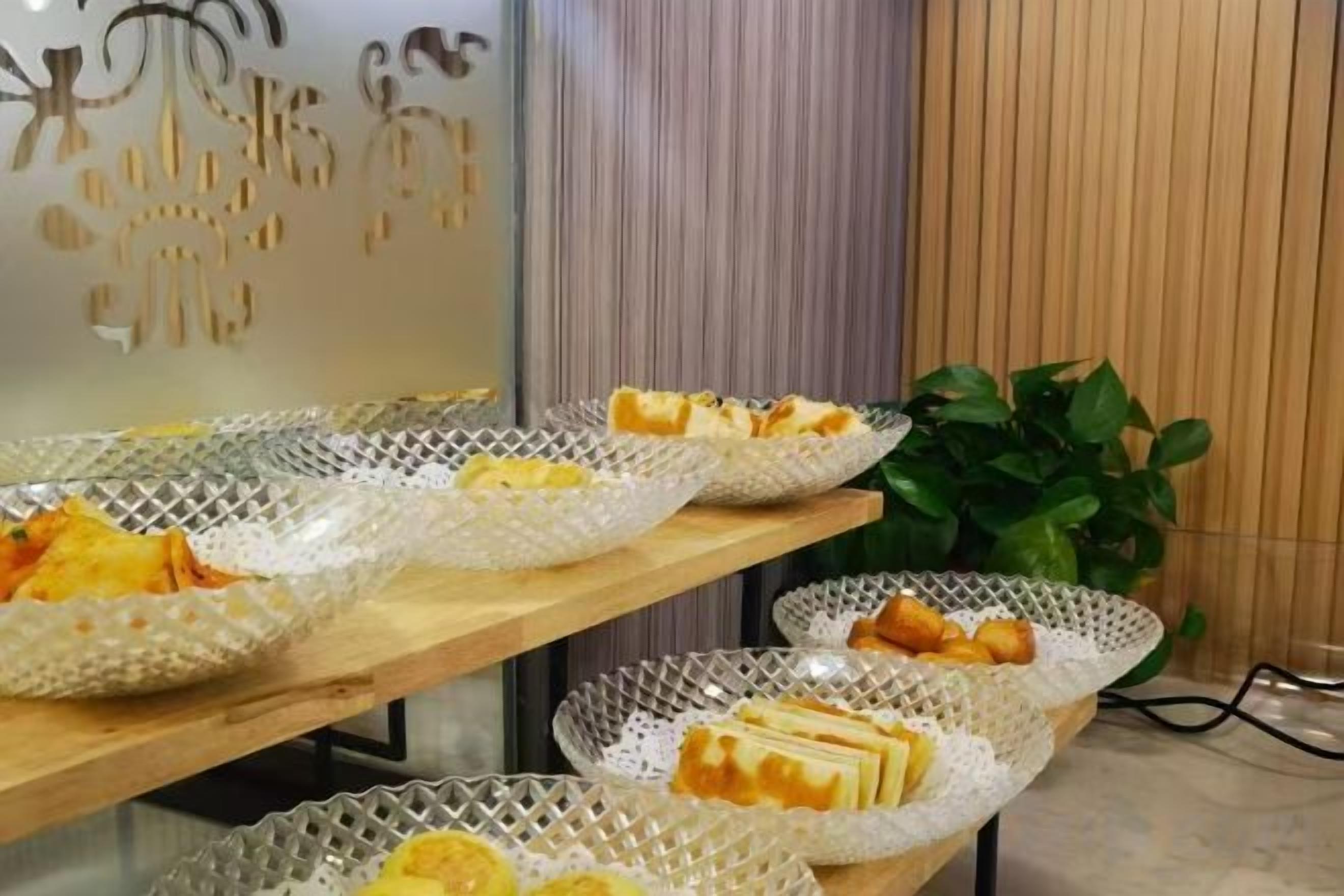 A buffet table with various food items.