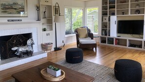 Ein Wohnzimmer mit Kamin, Fernseher und Bücherregal.