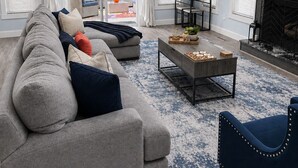 A living room with a sofa, armchairs, a coffee table, and a fireplace. - Modern Poconos Cabin w/ Hot Tub Near Kalahari & CamelBack Mountain ! (Long Pond)