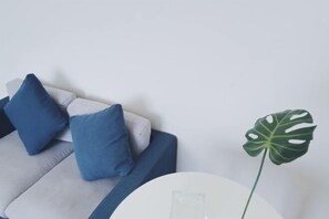 A modern living room with a sofa and a round table.