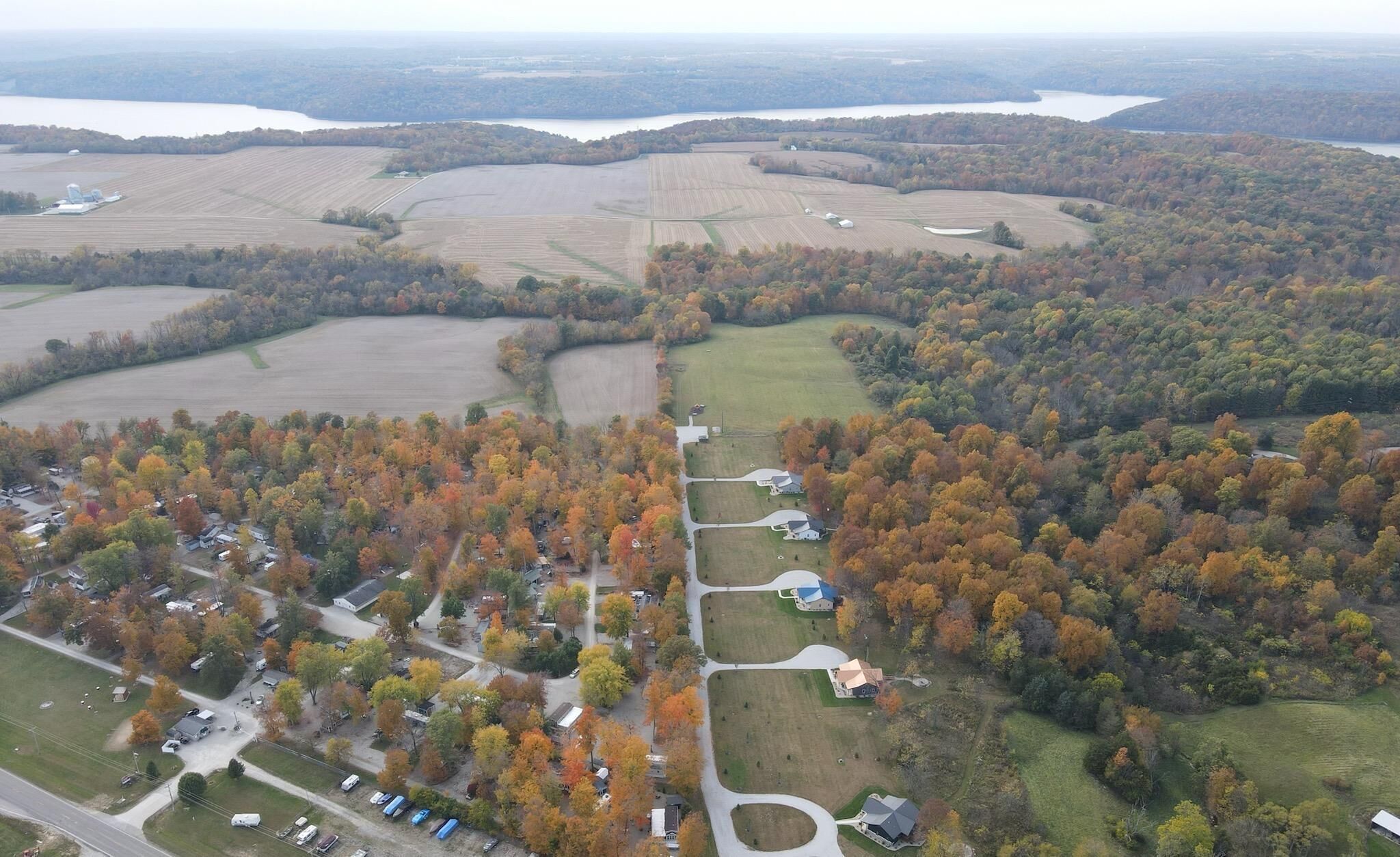 An aerial view of a residential area with houses, roads, and fields.