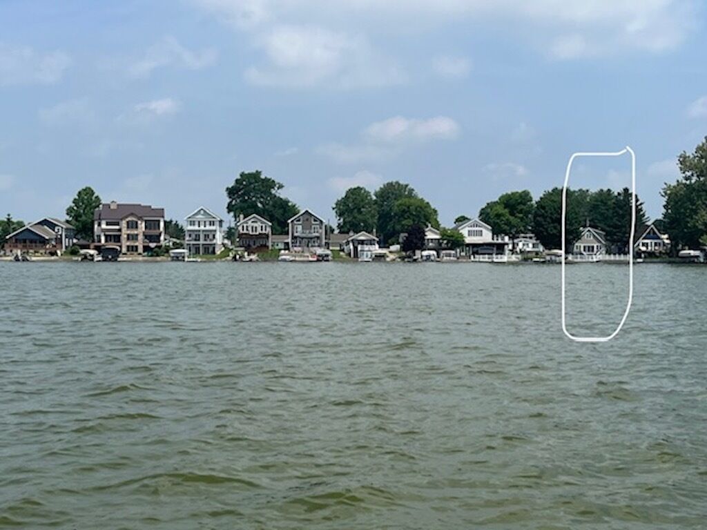 A waterfront property with multiple houses along the shore.