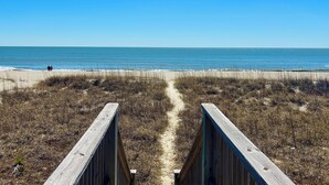 A beach pathway leading to the ocean with a clear sky. - Pet Friendly, Ocean Front w/ Heated Private Pool and Sun Deck (Brunswick)