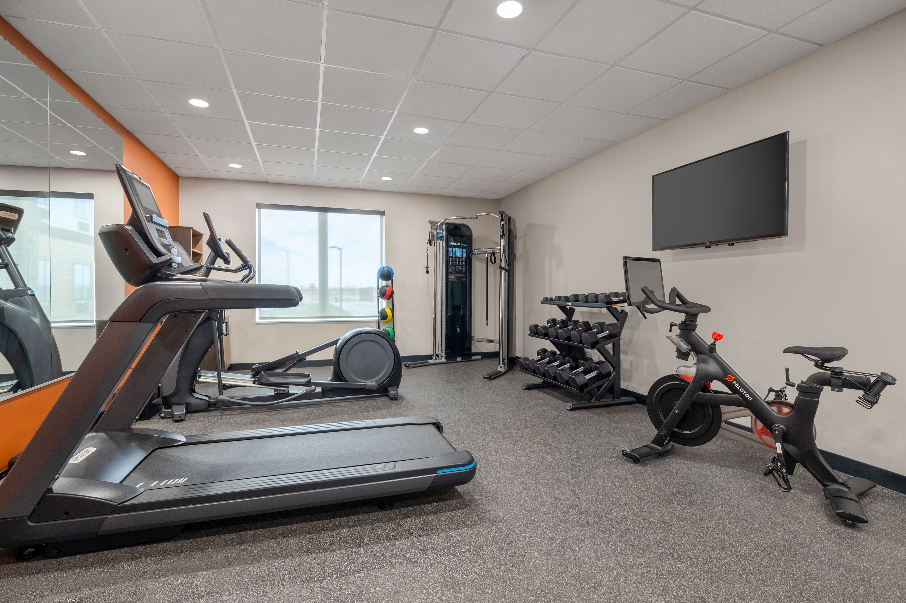 A gym with treadmills, stationary bikes, and weight machines.