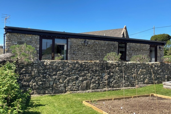 A large patio area overlooks our vegetable garden with views of the valley.