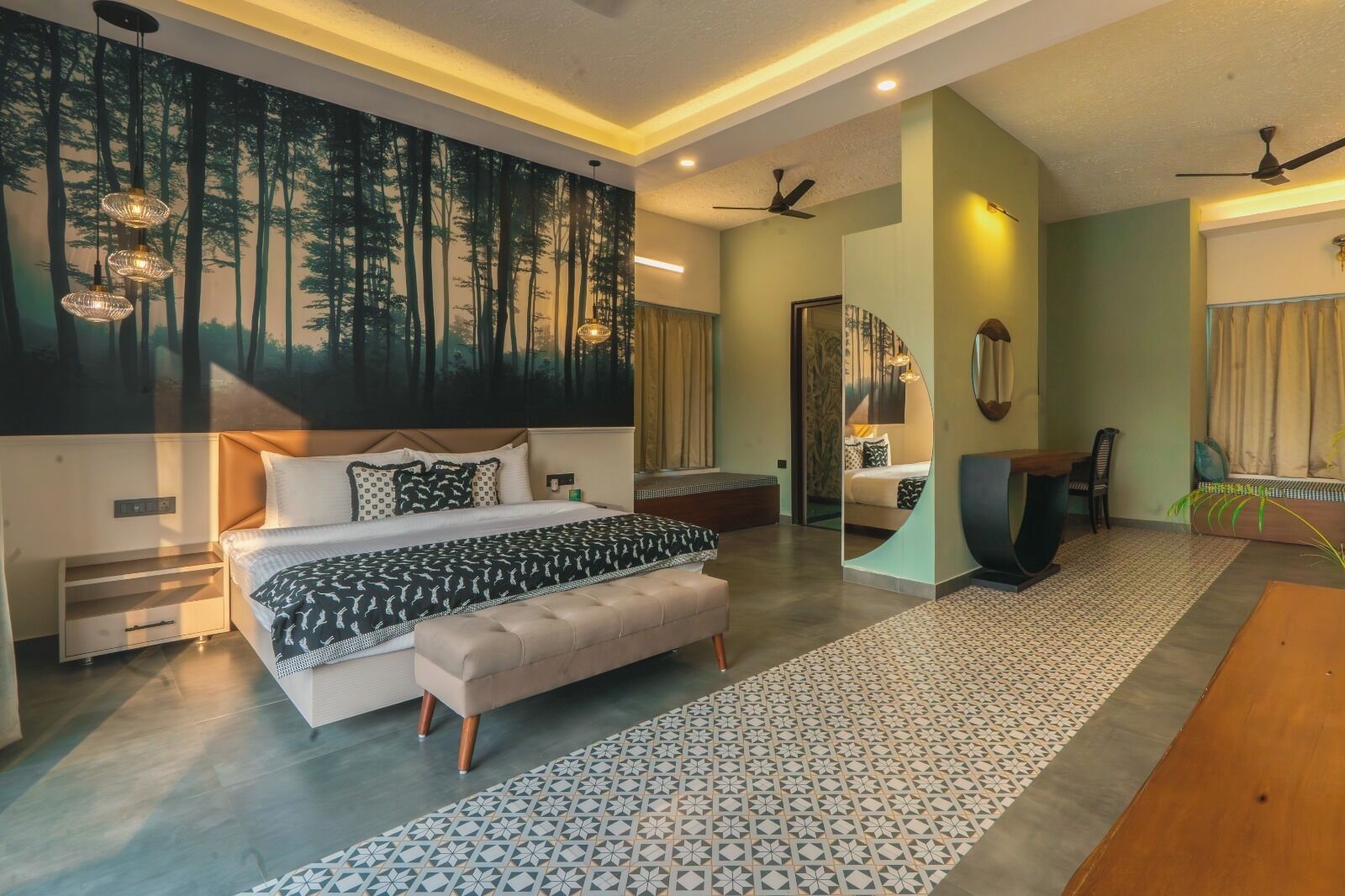 A modern bedroom with a large bed, a seating area, and a dining table.