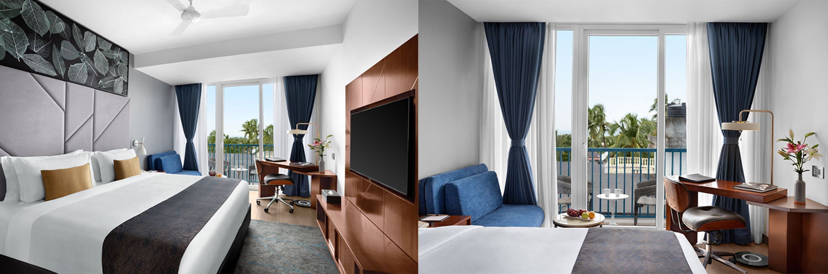 A hotel room with a bed, a desk, a TV, and a balcony with a view of palm trees.