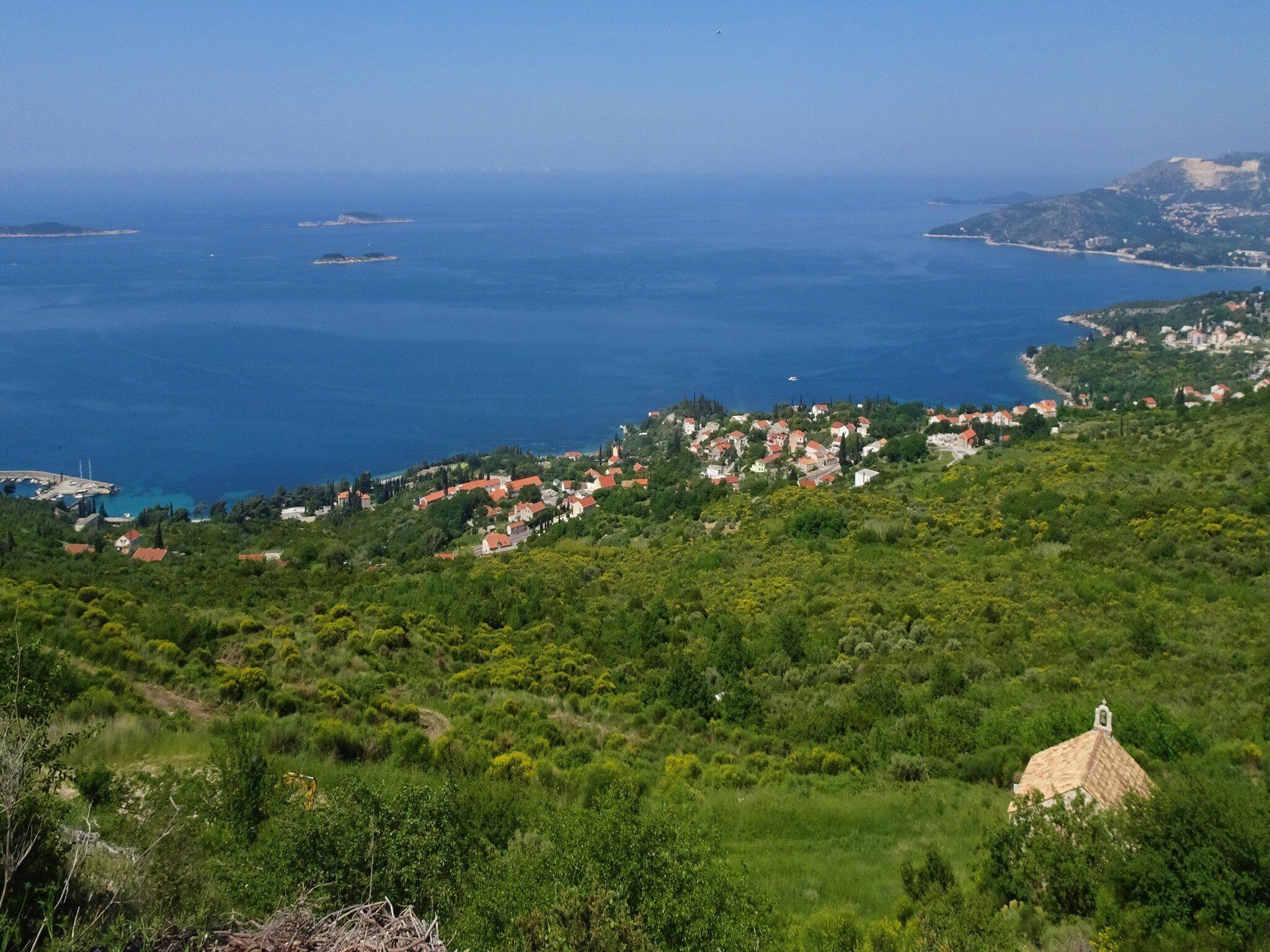 A coastal village with houses on a hillside, overlooking the sea.