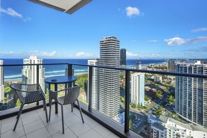 Relax and dine with a panoramic view of the coastal cityscape from this spacious balcony.