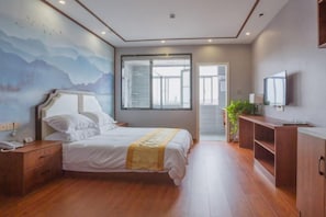 A bedroom with a bed, bedside table, a TV, a window, and a door leading to another room. - Shangpin Business Hotel (Guangde)