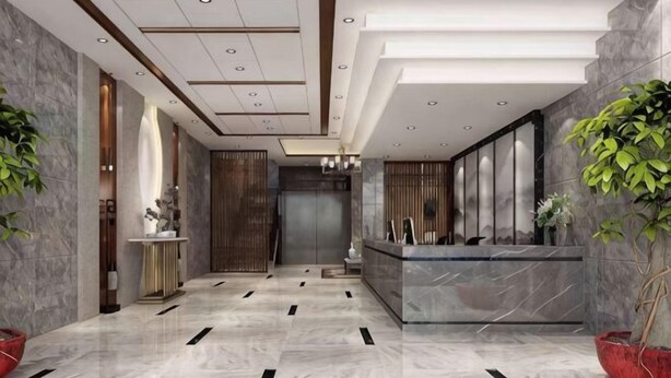A modern hotel lobby with a reception desk, a large mirror, and potted plants. - Shangpin Business Hotel (Guangde)