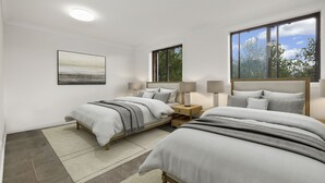 A modern bedroom with two beds, a large window, and a painting on the wall. - Alps Lakeview Lodge (East Jindabyne)